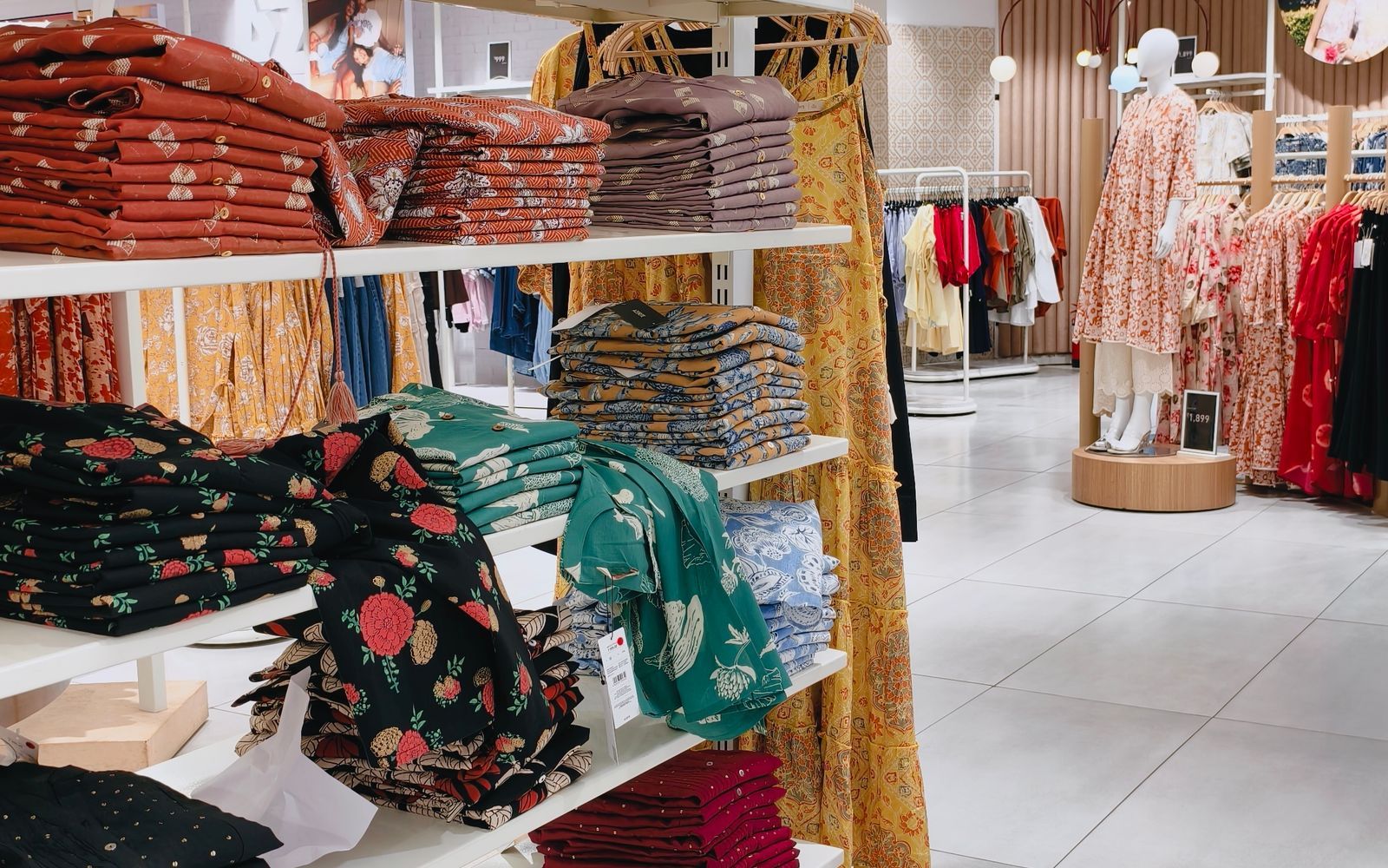 Bright retail clothing store with organized displays