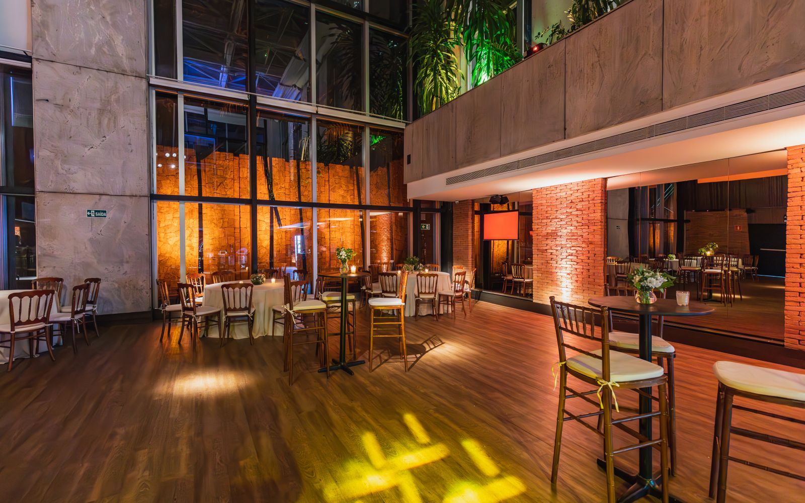 Atmospheric event venue with wood floors ready for setup