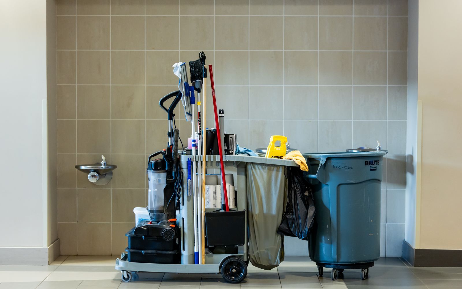 Fully stocked janitorial cart staged for daytime porter service