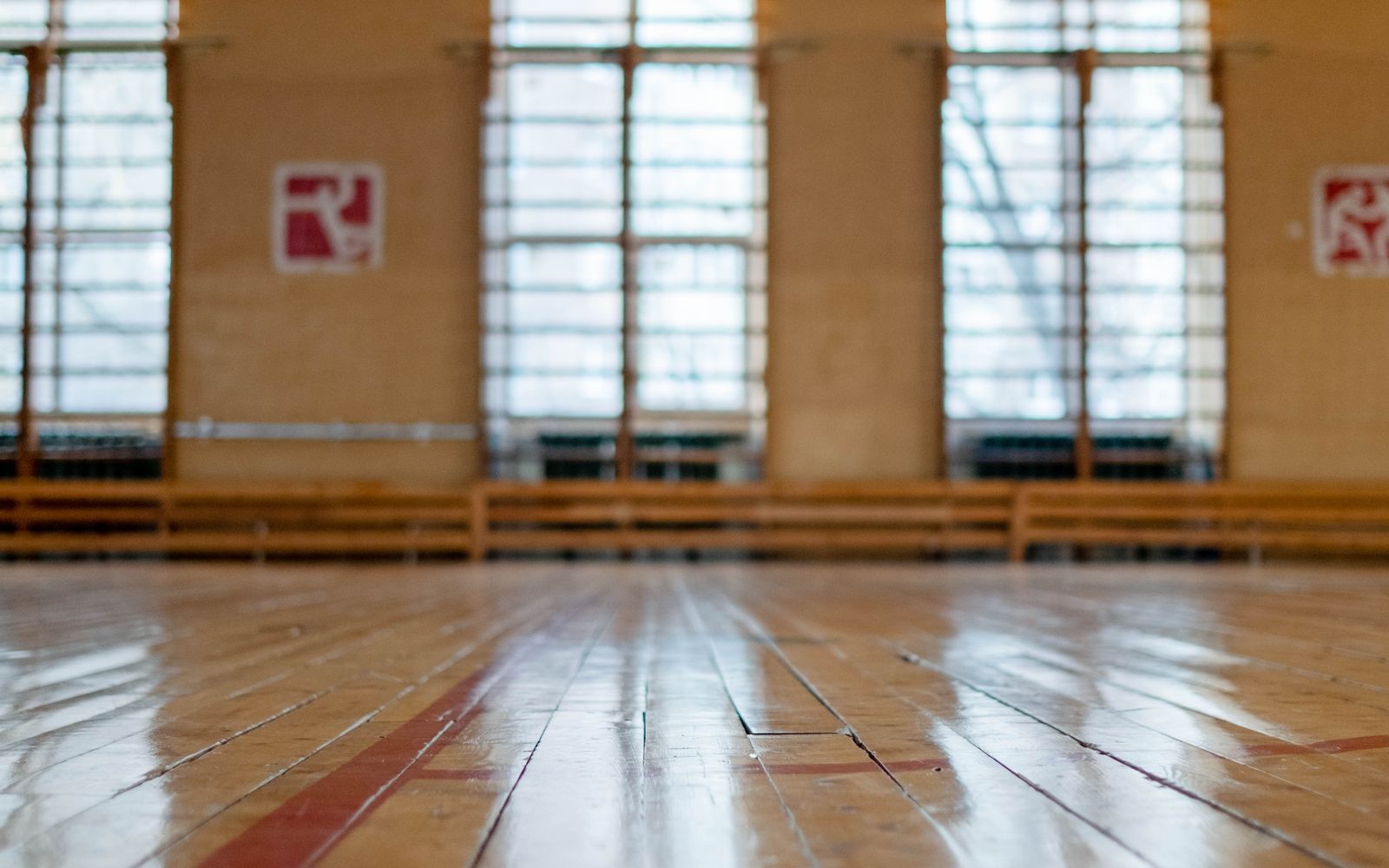 Sunlit commercial hall with a freshly finished wood floor